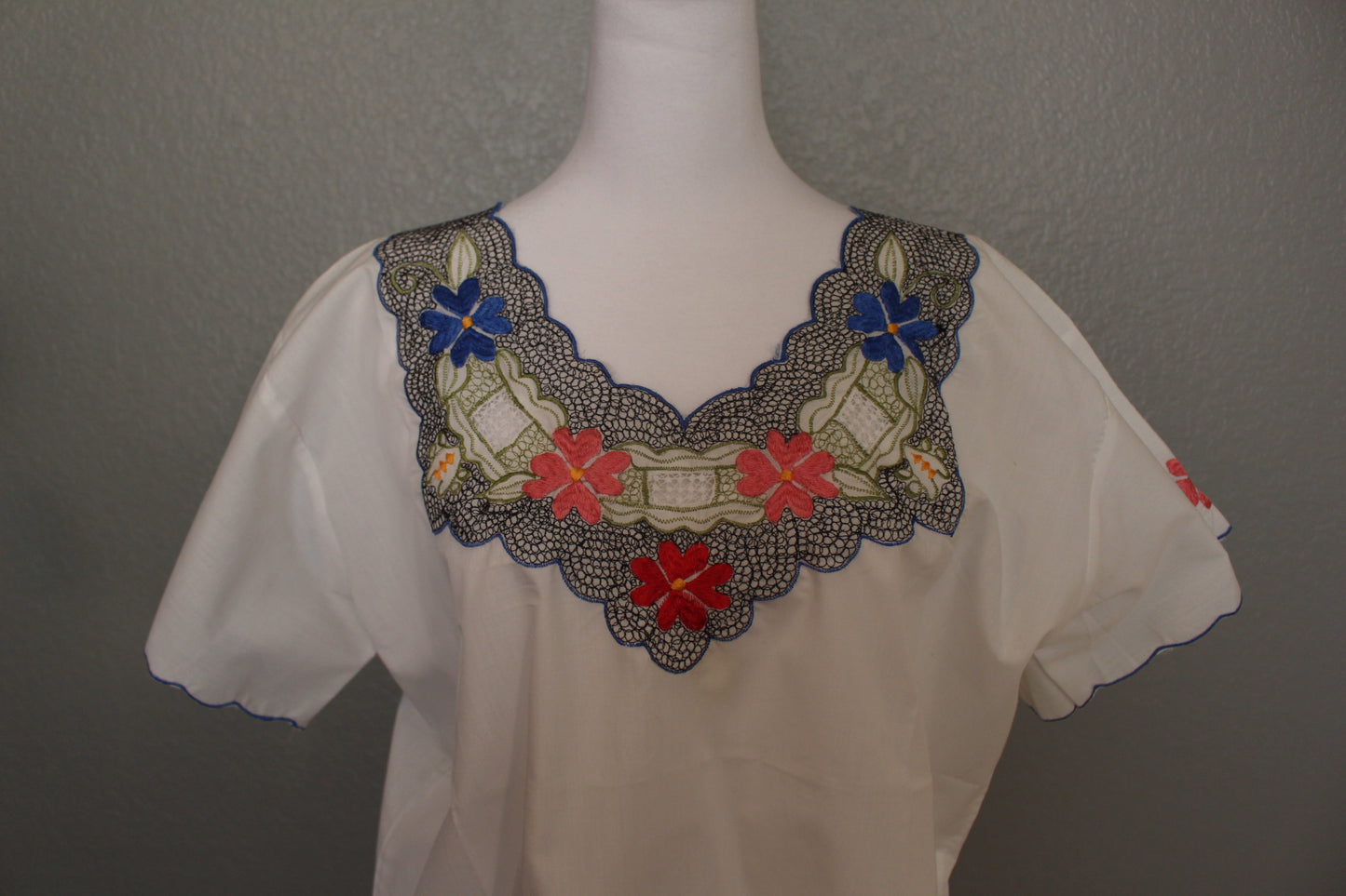 White Mexican Embroidered / Stitched Short Sleeve Shirt with scoop pattern with flowers.