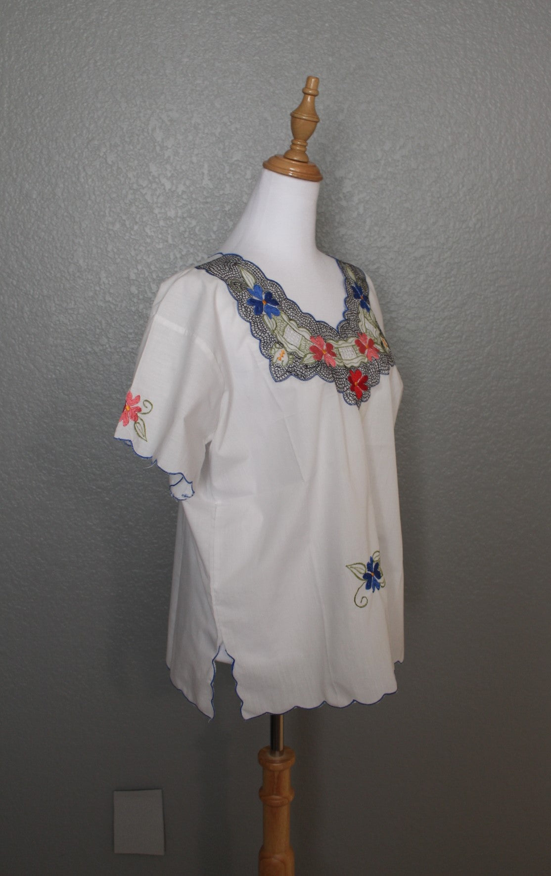 White Mexican Embroidered / Stitched Short Sleeve Shirt with scoop pattern with flowers.