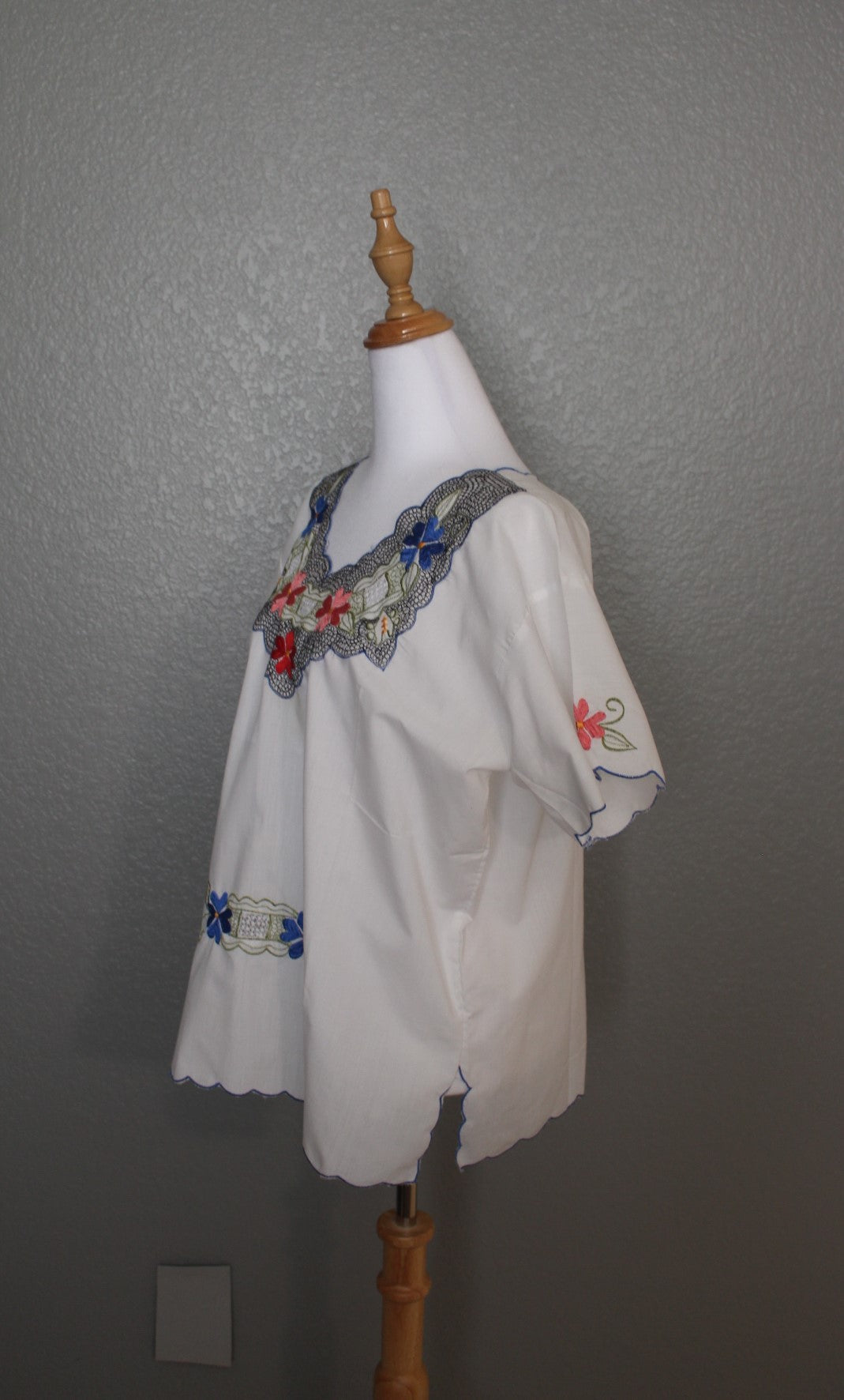 White Mexican Embroidered / Stitched Short Sleeve Shirt with scoop pattern with flowers.